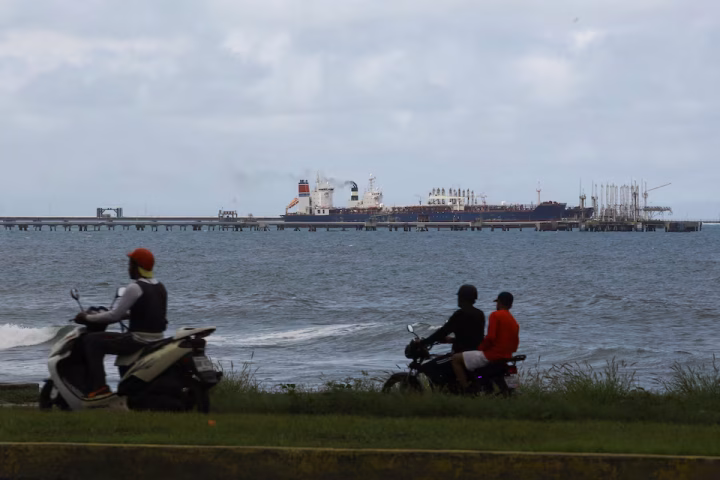 The Guinea-flagged oil tanker MT Bandra, which is under sanctions, is partially seen alongside another vessel at El Palito terminal, near Puerto Cabello, Venezuela December 29, 2025. REUTERS/Juan Carlos Hernandez (US oil investment Venezuela)